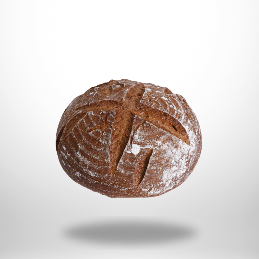 Goldbrauner glutenfreier Gewürzlaib (500 g) mit rustikaler Kruste; Kümmel- und Koriandersamen sichtbar.