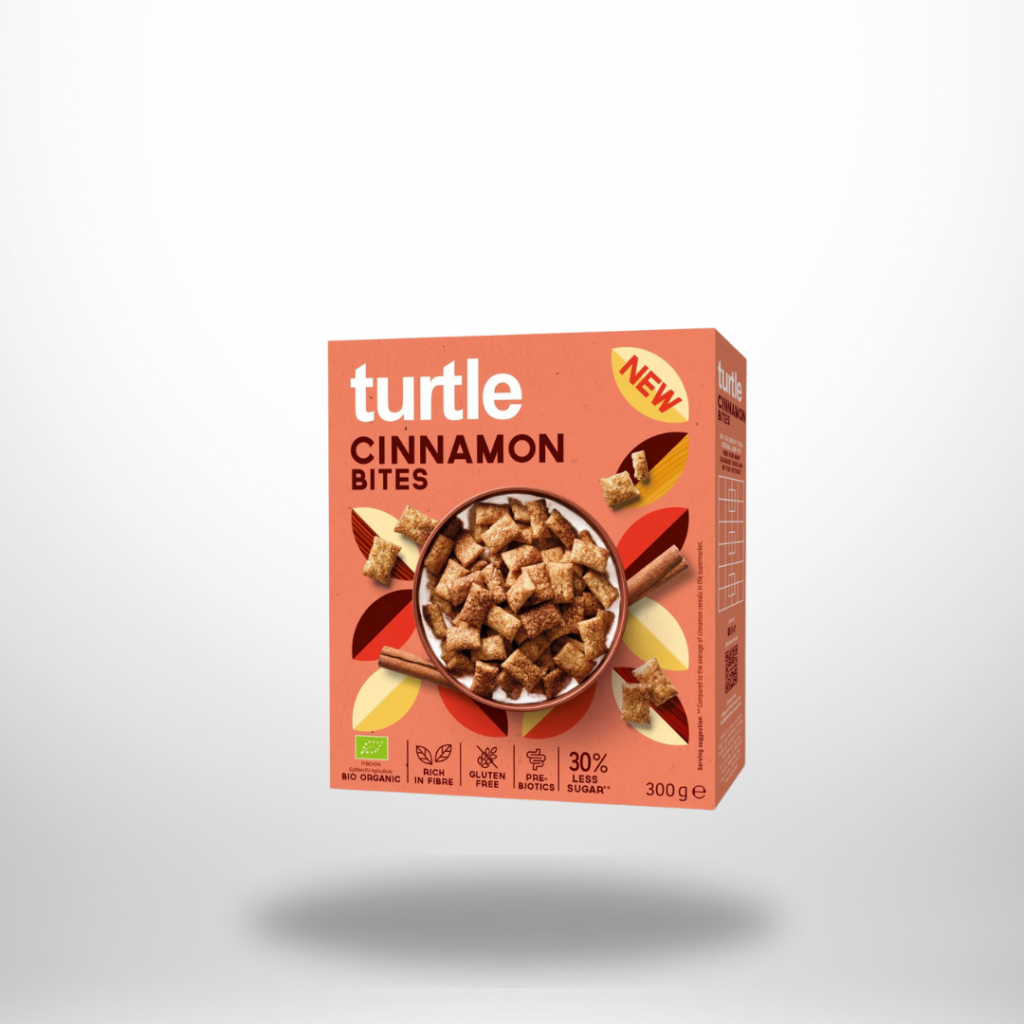 Orange Turtle-Packung „Cinnamon Cereals“ mit Sichtfenster voll zimtbrauner Hafer-Cluster (300 g, Bio & glutenfrei).