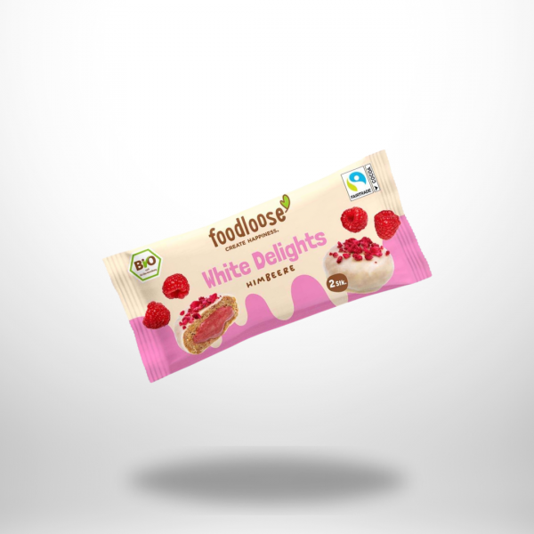 Verpackung der foodloose White Delights Himbeere mit Abbildung zweier veganer Dattelkugeln, umhüllt von weißer Schokolade und gefüllt mit Himbeerpüree. Bio- und Fairtrade-zertifiziert.
