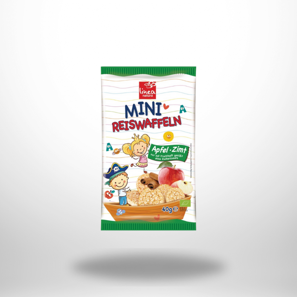 Gelb-grüner 40-g-Beutel „Pural Mini Reiswaffeln Apfel Zimt“ mit Reis­waffeln und Apfel-Zimt-Grafik.