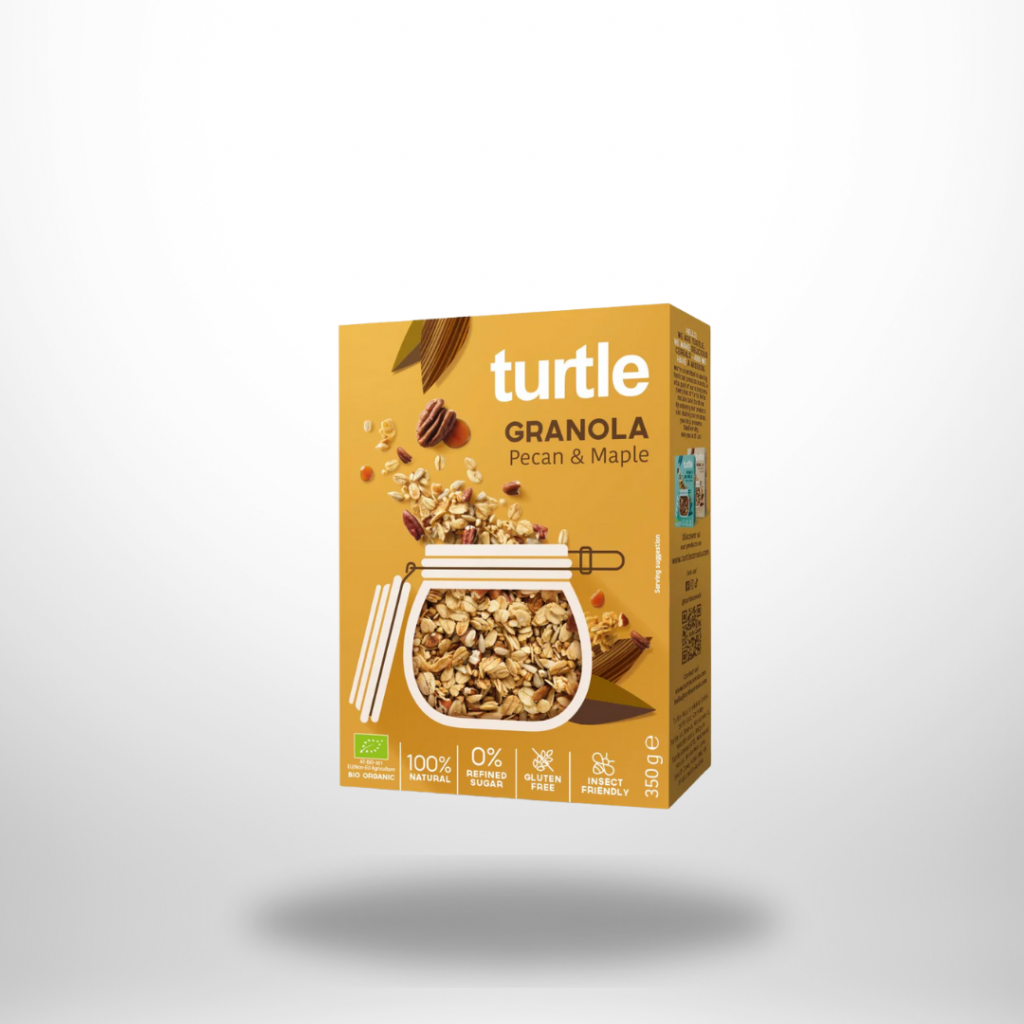 Turtle Granola Pecan & Maple – 350 g Karton mit Glasfenster, Ahorn & Pekannuss-Motiv.